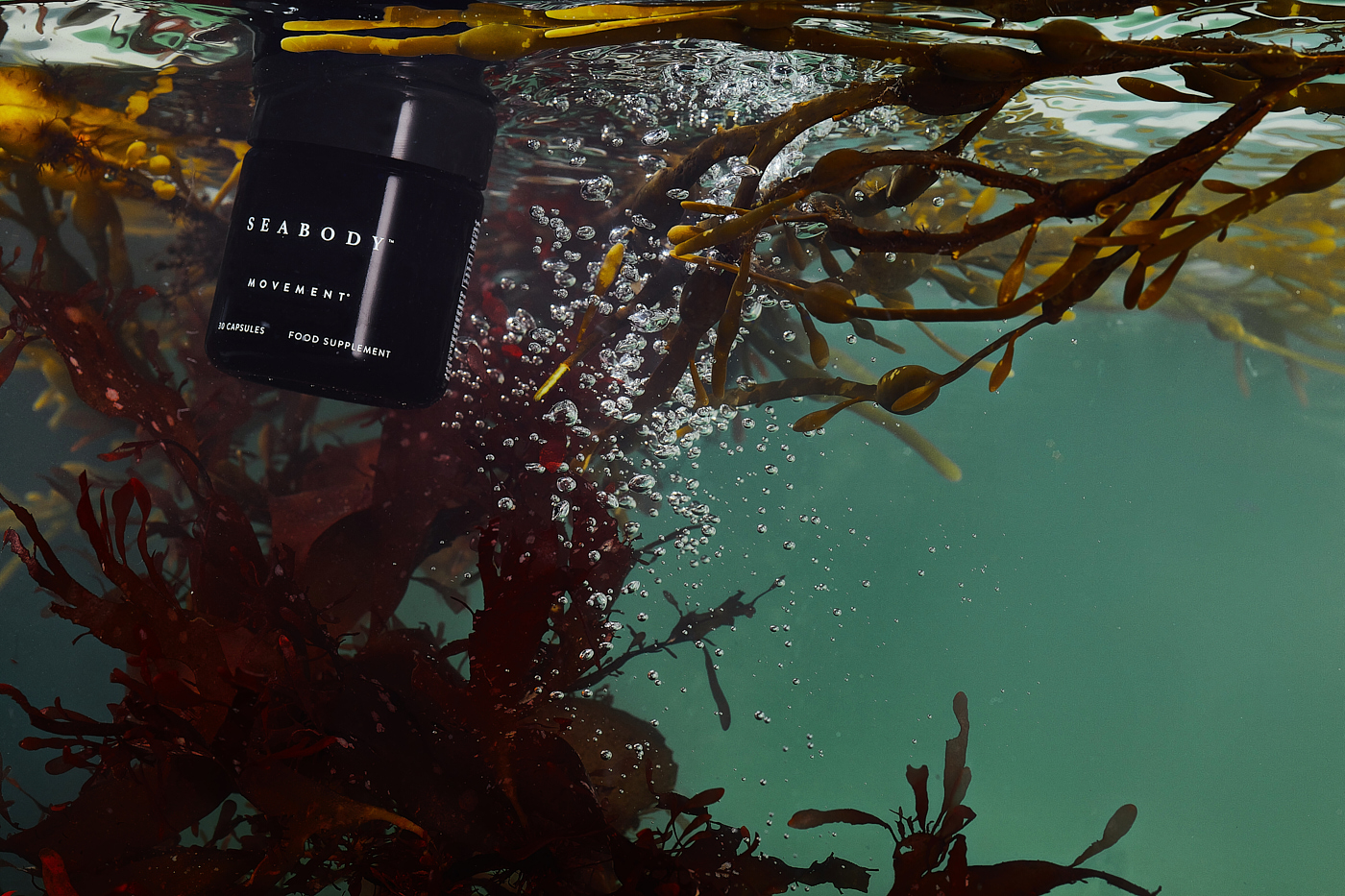 Liquid Photography - Beauty product underwater with seaweed. 